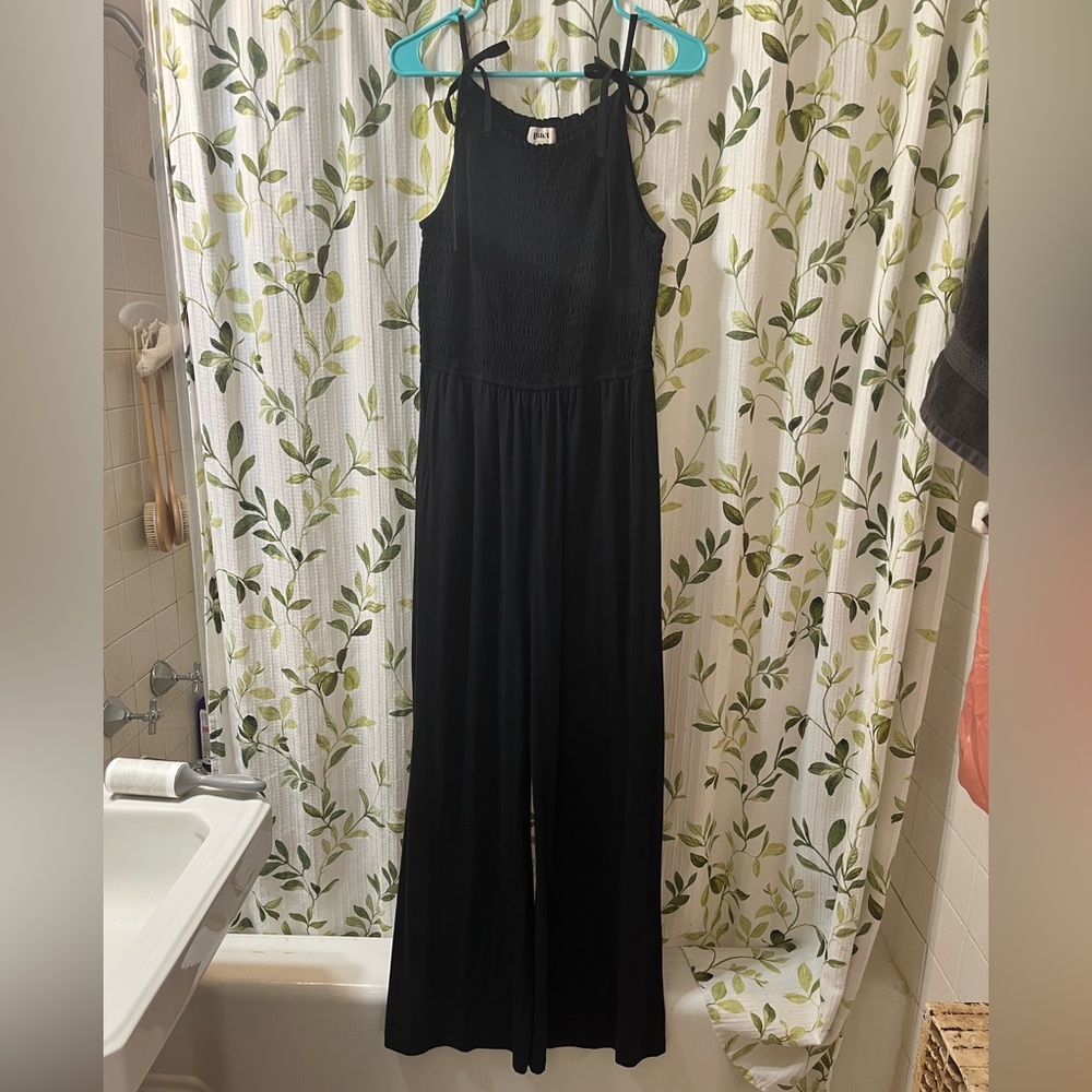 Pact “Soirée One‑And‑Done” Black Smocked Flare Jumpsuit – M – Organic Cotton